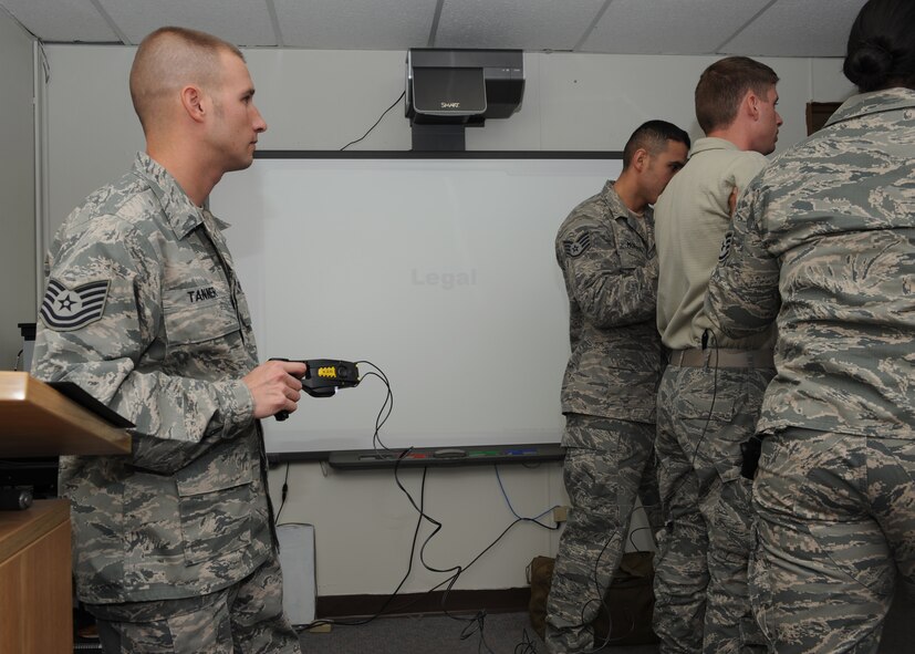 Tech. Sgt. Ryan Tanner, 7th Security Forces Squadron, prepares to shock Airman 1st Class Jason Utley, 7 SFS, with a taser during training Nov. 9, 2011 at Dyess Air Force Base, Texas. Training is conducted annually to ensure 7 SFS airmen are qualified to use a taser. (U.S. Air Force photo by Airman 1st Class Jonathan Stefanko/ Released)