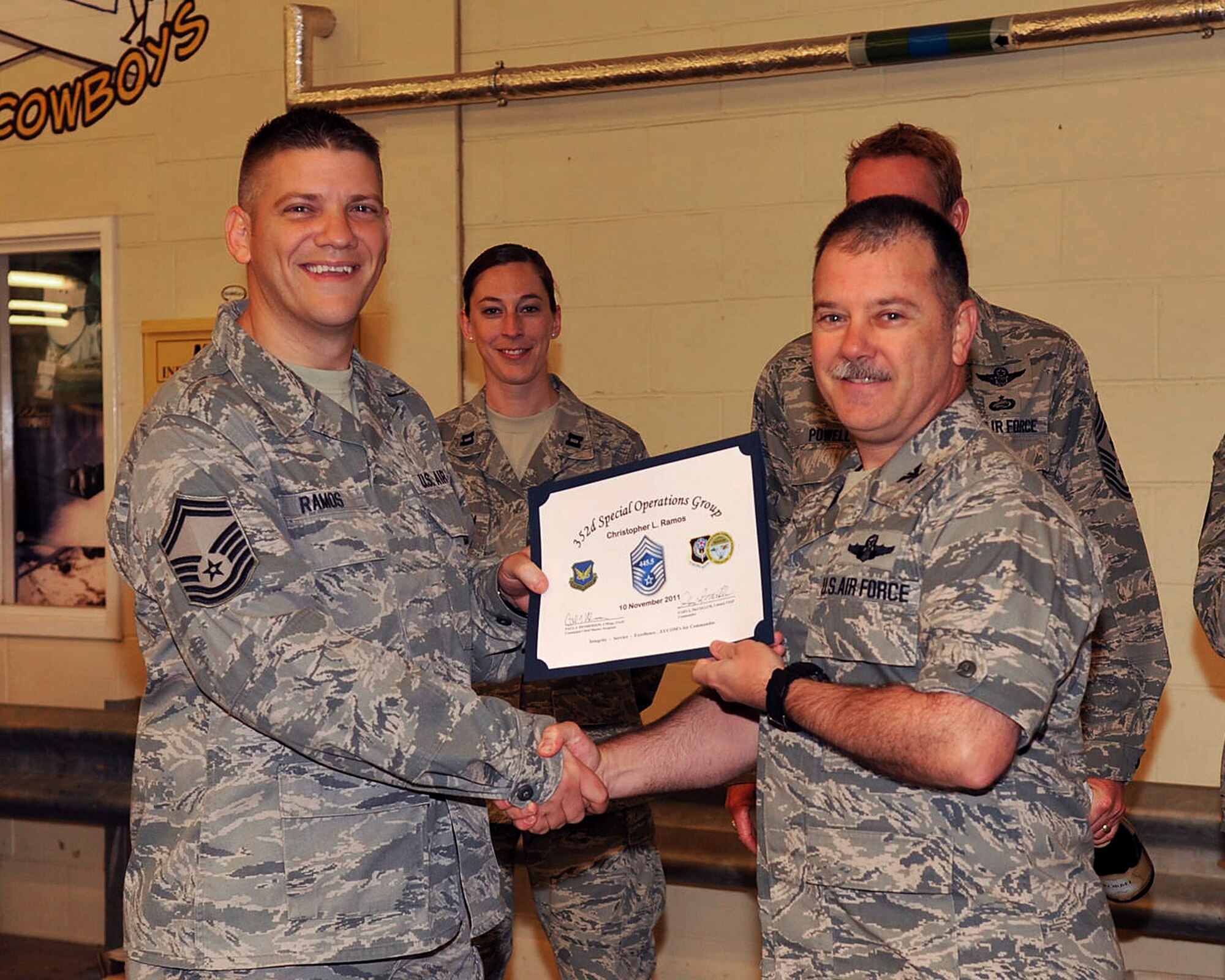 RAF MILDENHALL, England - Col. Gary McCollum, 352nd Special Operations Group commander, right, presents a congratulatory certificate to Senior Master Sgt. Christopher Ramos, 352nd Special Operations Support Squadron, upon being selected for promotion to the rank of chief master sgt. here Nov. 10, 2011. Ramos is the 352nd SOSS communications flight chief. (U.S. Air Force photo/Senior Airman Jerilyn Quintanilla)
