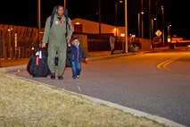 Tech. Sgt. Corey Legette, 461st Air Control Wing flight crew member, walks away from the flightline with his son upon his return from deployment supporting operations in Libya. Legette is a part of the combined U.S. Air Force 116th and 461st ACW and U.S. Army 138th Military Intelligence Company, flying the E-8C Joint STARS aircraft. U. S. Air Force photo by Master Sgt. Roger Parsons