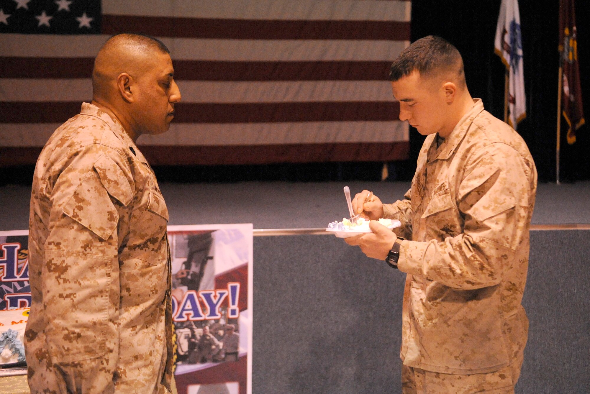 Lance Cpl. Justin Dorrell takes a bite of Marine Corps’ birthday cake as Master Gunnery Sgt. M. G. Duarte watches during a ceremony celebrating the Corps’ 236th birthday at the Transit Center at Manas, Kyrgyzstan, Nov. 10. It is tradition for the birthday celebration’s special guest to receive the first bite of cake, followed by the oldest and youngest Marine on the installation. Dorrell, the youngest Marine at the Transit Center, is deployed from Cherry Point, N.C. Duarte, the oldest Marine at the Transit Center, is deployed from the Western Recruiting Region, San Diego, Calif. (U.S. Air Force photo/Tech. Sgt. Tammie Moore)