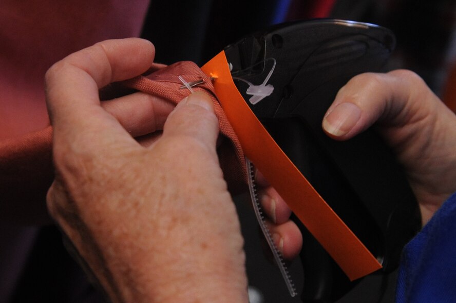 Ingrid Quick, a retired military spouse, adds a price tag to a clothing item at the Thrift Shop on Seymour Johnson Air Force Base, N.C., Nov. 8, 2011. From June 2010 through May 2011 the Thrift Shop donated $9454.53 to the Enlisted Spouse Club and the Officer Civilian Spouses Club. The money was given out to spouse and dependent scholarships and the local community. Quick volunteers at the Thrift Shop as a way of giving back to the U.S. Air Force for all they have done while her husband was active duty. Quick hails from Goldsboro, N.C. (U.S. Air Force photo by Senior Airman Whitney Stanfield)