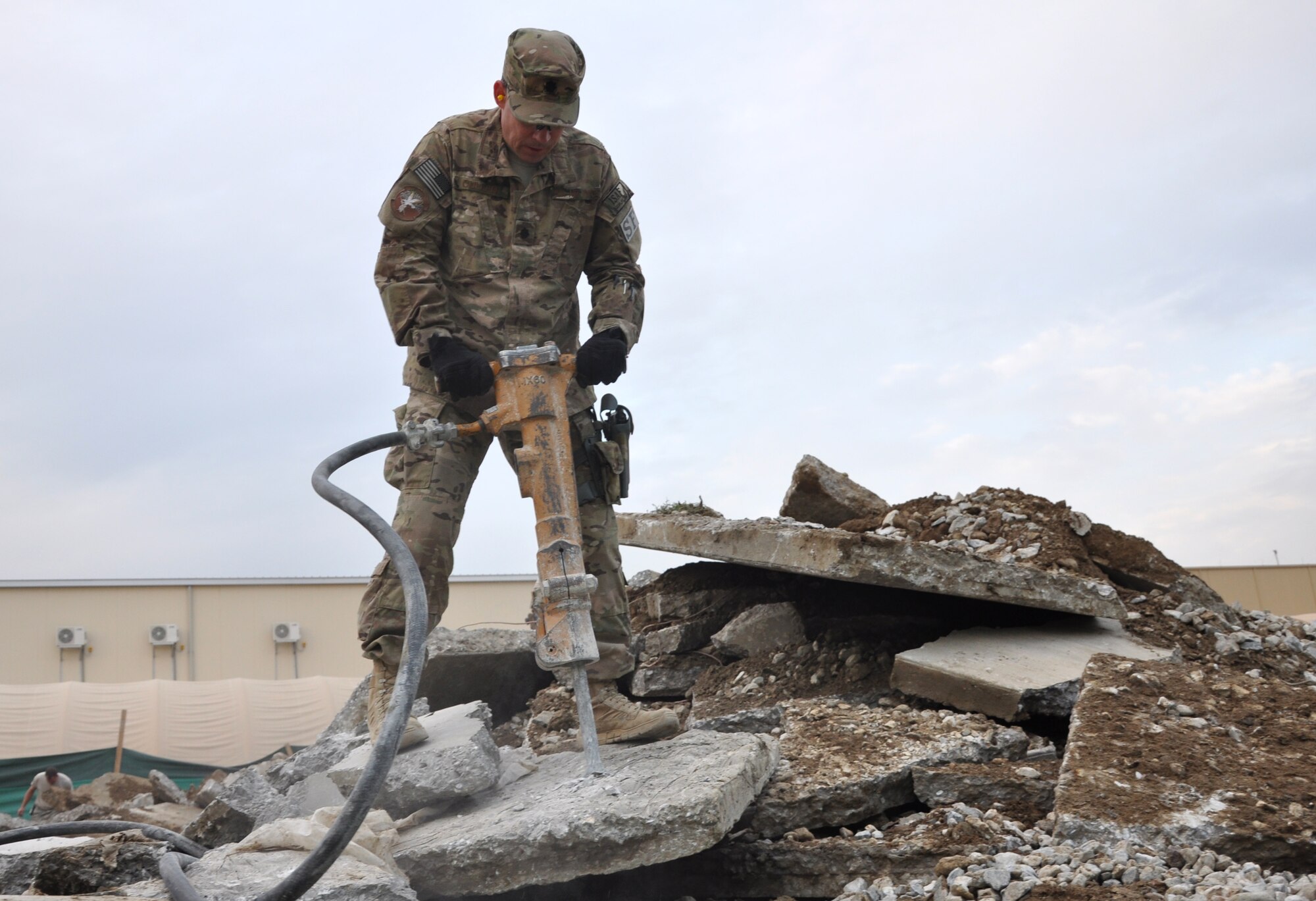 Lt. Col. Kevin Cullen, 455th Expeditionary Security Forces Squadron commander, breaks up concrete with a jackhammer Nov. 10, 2011. Defenders are working side by side with Airmen from the 455th Expeditionary Civil Engineer Squadron to construct a new security forces building. Their combined efforts will speed up the construction process and provide improved facilities for Bagram’s Airmen. (U.S. Air Force photo/Staff Sgt. John Wright)