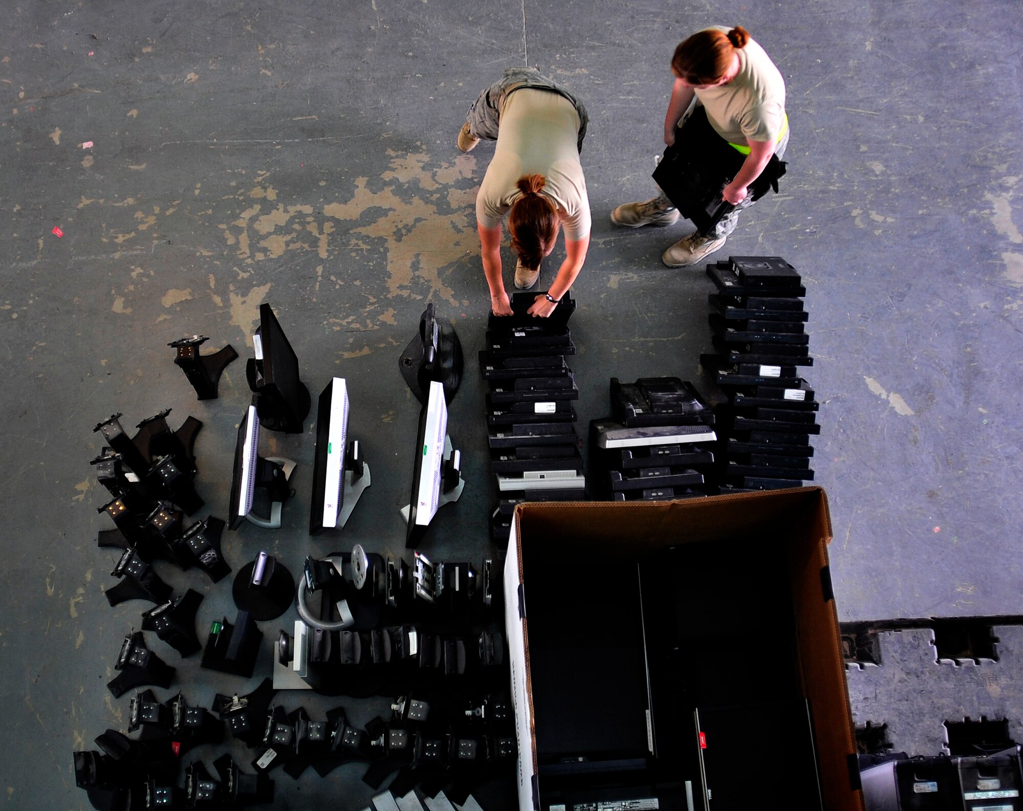 Airman 1st Class Heather O'Donnell, 332nd Air Expeditionary Wing base equipment control officer, and Senior Airman Roxanne Chambers, 332nd AEW cyber transporter, prepare and organize turned-in equipment at Joint Base Balad, Iraq, Oct. 15, 2011. JB Balad has disassembled units, turned in equipment, and shut down services to transition the base to the Iraqi government. O'Donnell is deployed from Royal Air Force Lakenheath, England, and is from Eugene, Ore.  Chambers is deployed from Montgomery, Ala., and is from Elmore, Ala.  (U.S. Air Force photo/Master Sgt. Cecilio Ricardo)