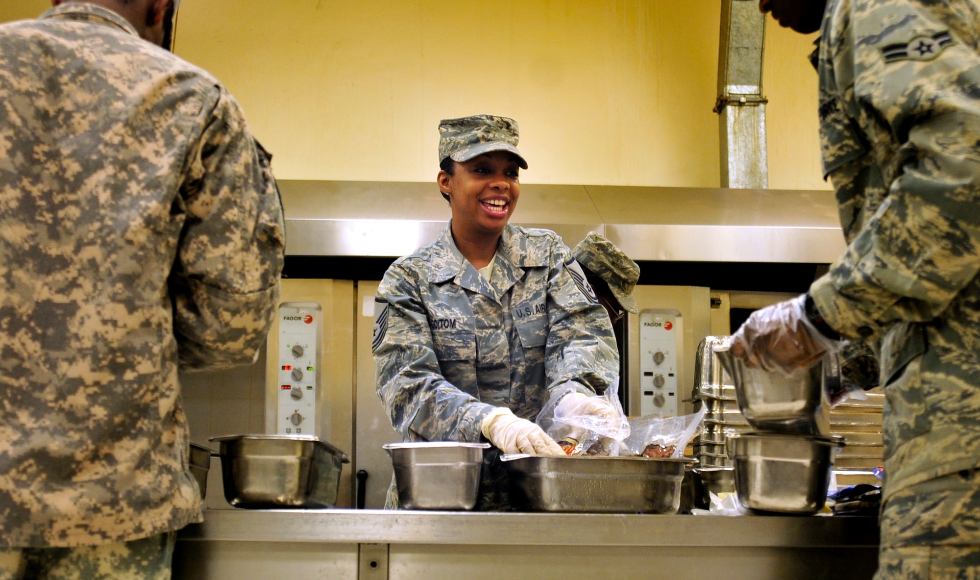 Master Sgt. Melody Goitom, dining facility manager, prepares food at the dining facility at Joint Base Balad, Iraq, Oct. 15, 2011. With the release of food services contractors, Airmen and soldiers joined together at the dining facility to feed the troops during the closure of JB Balad.  JB Balad has disassembled units, turned in equipment, and shut down services to transition the base to the Iraqi government. Goitom is deployed from Misawa Air Base, Japan, and is from Detroit. (U.S. Air Force photo/Master Sgt. Cecilio Ricardo)