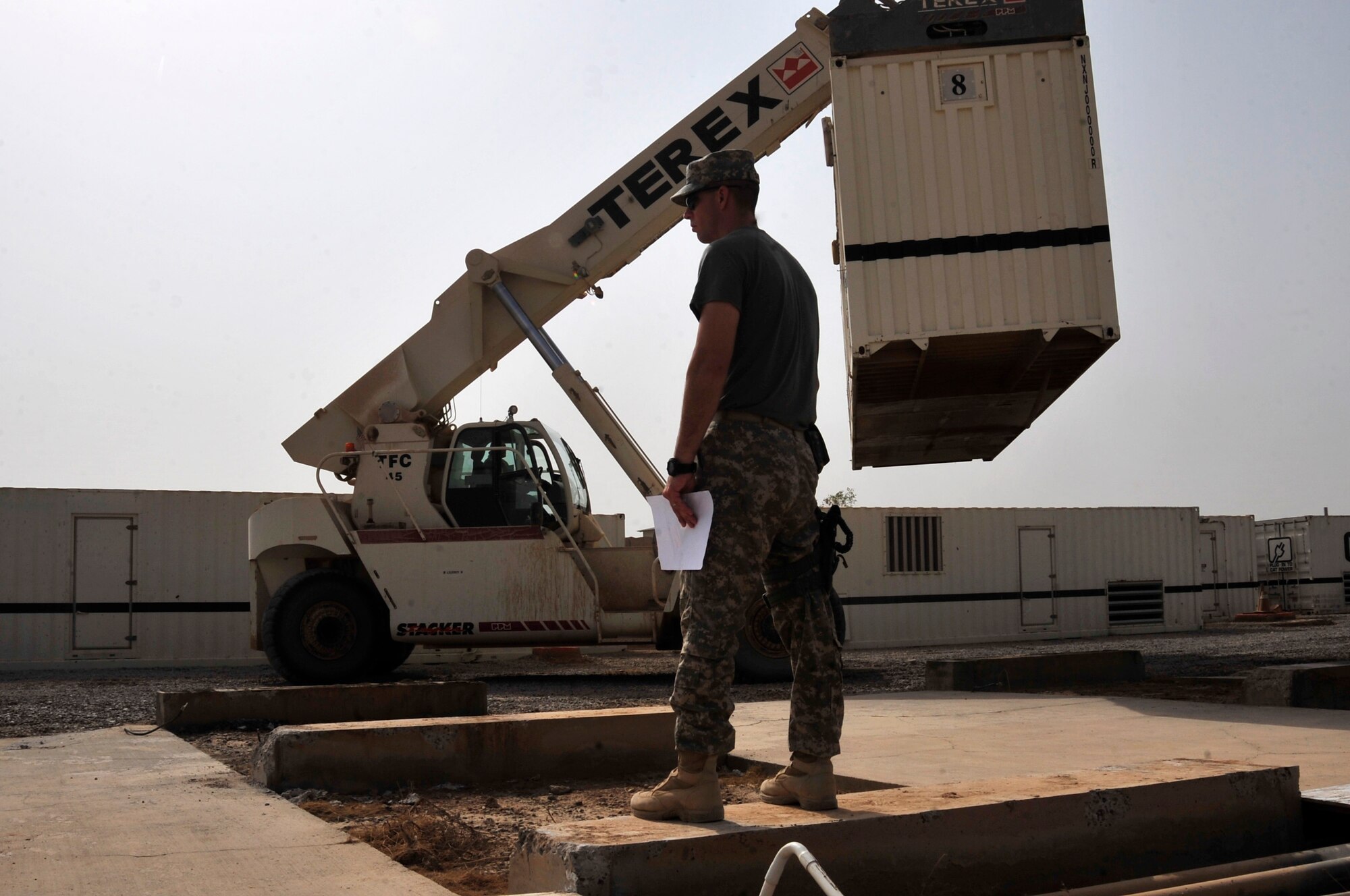 Sgt. 1st Class Aaron Sanders, prime power contracting officer, directs the movement of generators at Joint Base Balad, Iraq, Oct. 15, 2011. Eight generators were redistributed as part of JB Balad’s closure. JB Balad has disassembled units, turned in equipment, and shut down services to transition the base to the Iraqi government. (U.S. Air Force photo/Master Sgt. Cecilio Ricardo)