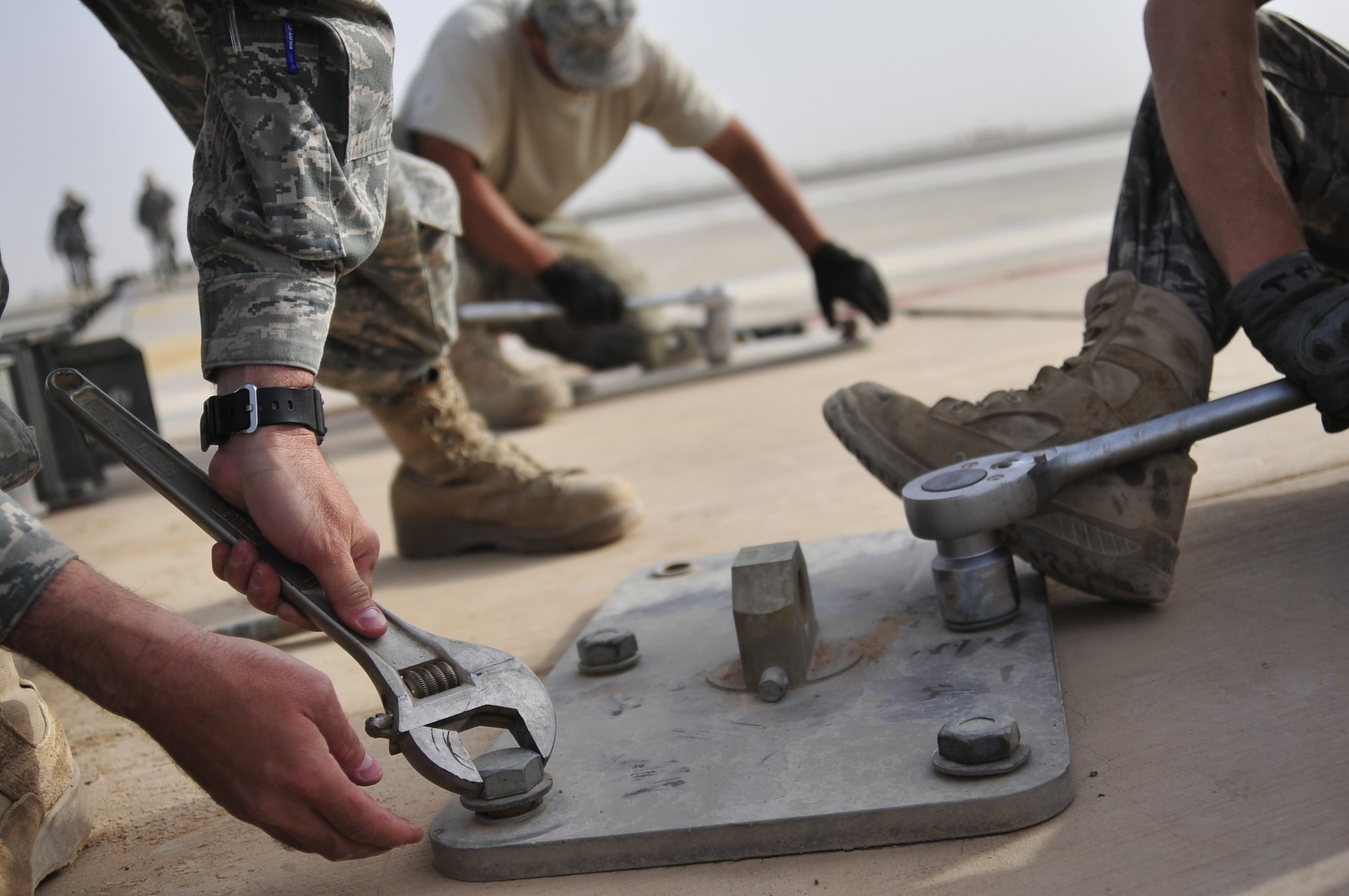 Electric power production Airmen from the 332nd Expeditionary Civil Engineer Squadron, disassemble the anchor plates of a mobile aircraft arresting system on the flight line of Joint Base Balad, Iraq, Oct. 15, 2011. JB Balad has disassembled units, turned in equipment, and shut down services to transition the base to the Iraqi government. (U.S. Air Force photo/Master Sgt. Cecilio Ricardo)