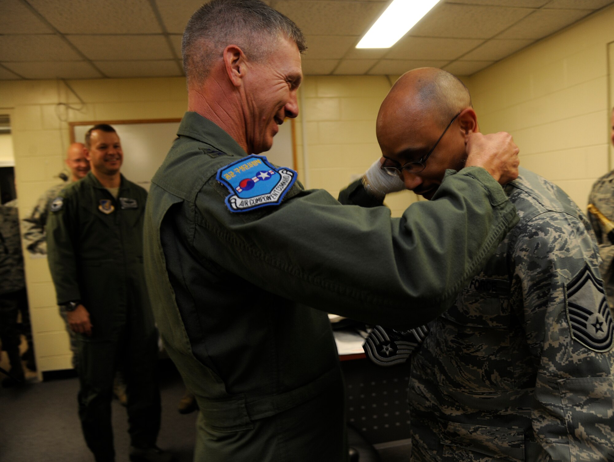 Lt. Gen. Jeffrey A. Remington, Seventh Air Force, Air Forces Korea commander, congratulates Senior Master Sgt. Dwayne Menefee, 8th Maintenance Operations Squadron, on his selection for promotion to chief master sergeant at Kunsan Air Base, Republic of Korea, on Nov. 3, 2011. (U.S. Air Force photo by Staff Sgt. Rasheen Douglas/Released)