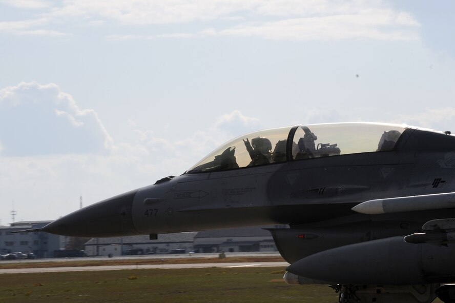 MISAWA AIR BASE, Japan -- Capt. Nicholas Edwards, 14th Fighter Squadron, shows the "the claw" as he taxis down the runway during an operational readiness exercise here Nov. 9. The 35th Fighter Wing is going through rehearsed procedures, during a base ORE,to train for the operational readiness inspection next month. (U.S. Air Force photo/Airman Kenna Jackson) 