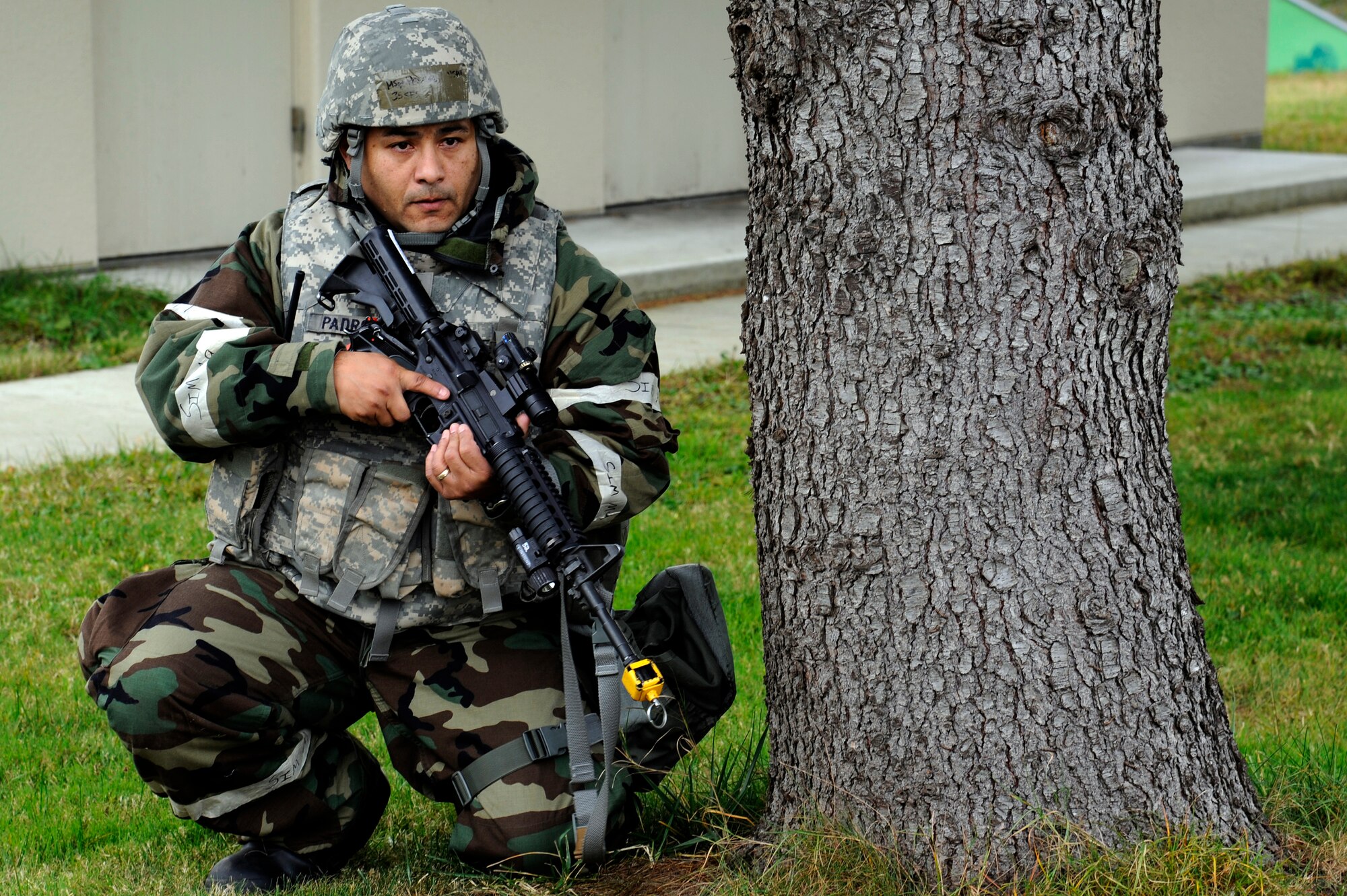 MISAWA AIR BASE, Japan - Master Sgt. Christopher Padron, 35th Security Forces Squadron, takes a defensive posture behind a tree during a training scenario, which was part of an operational readiness exercise here Nov. 9. The 35th Fighter Wing is going through rehearsed procedures, during a base ORE, to train for the operational readiness inspection next month. (U.S. Air Force photo/Tech. Sgt. Marie Brown)