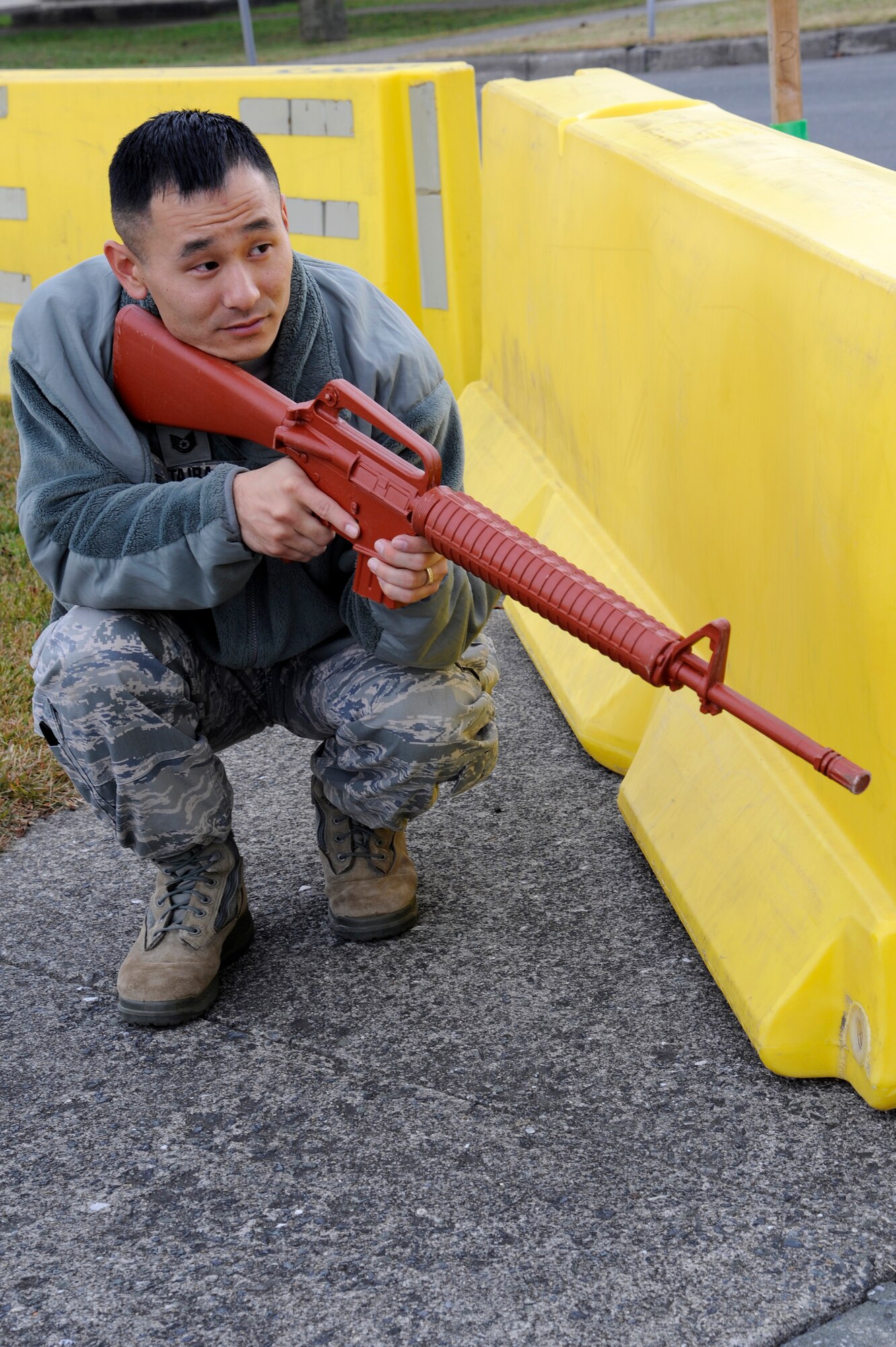 MISAWA AIR BASE, Japan - Tech. Sgt. Ryan Taira, 35th Security Forces Squadron, takes a defensive posture behind a barrier during a training scenario, which was part of an operational readiness exercise here Nov. 9. The 35th Fighter Wing is going through rehearsed procedures during a base ORE, to train for the operational readiness inspection next month. (U.S. Air Force photo/Tech. Sgt. Marie Brown)