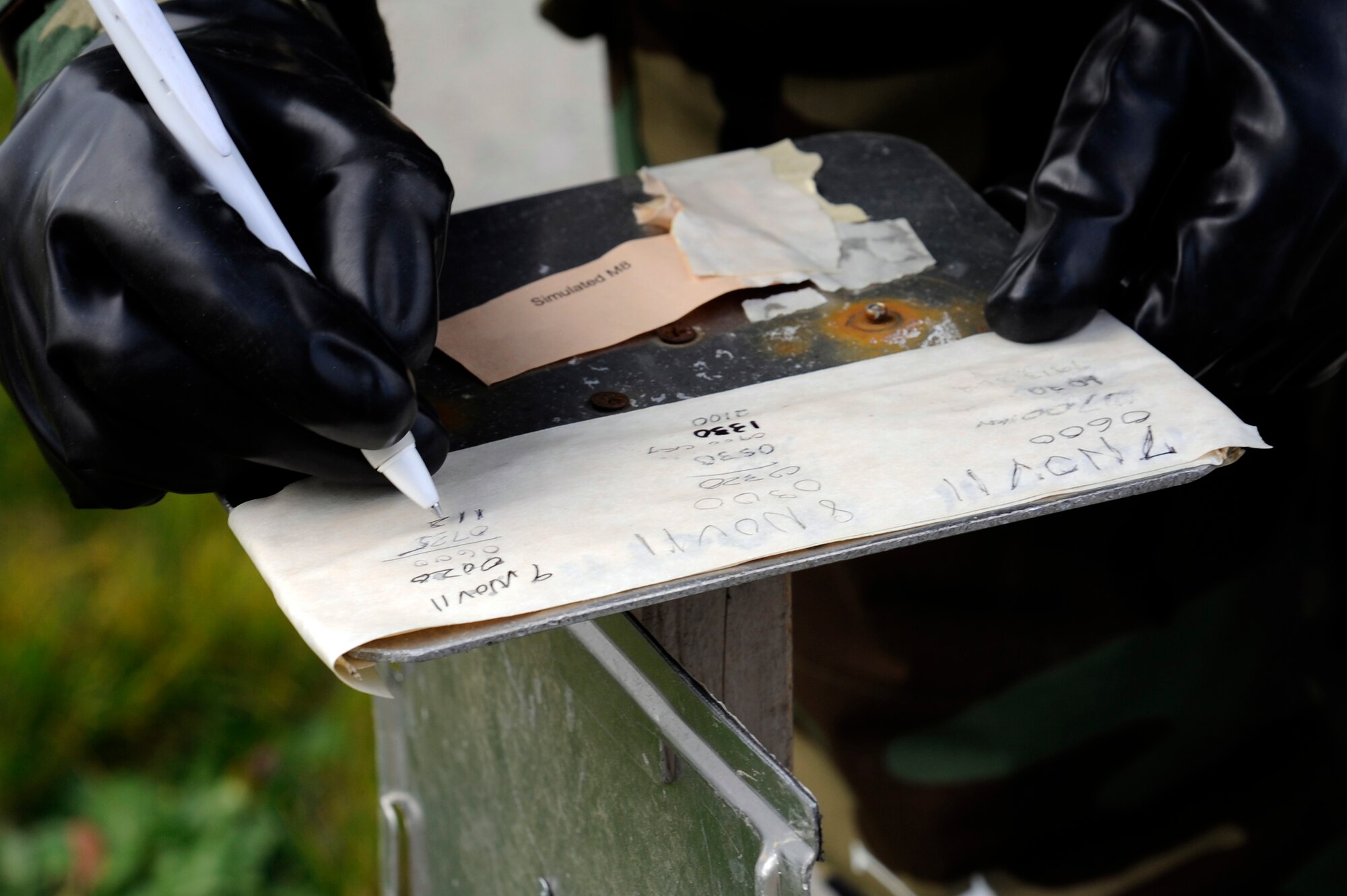 MISAWA AIR BASE, Japan - Senior Airman Steven Winslow, 35th Maintenance Squadron, annotates the date and time after checking simulated M8 paper while performing a post attack reconnaissance sweep during an operational readiness exercise here Nov. 9. The 35th Fighter Wing is going through rehearsed procedures during a base ORE, to train for the operational readiness inspection next month. (U.S. Air Force photo/Tech. Sgt. Marie Brown)