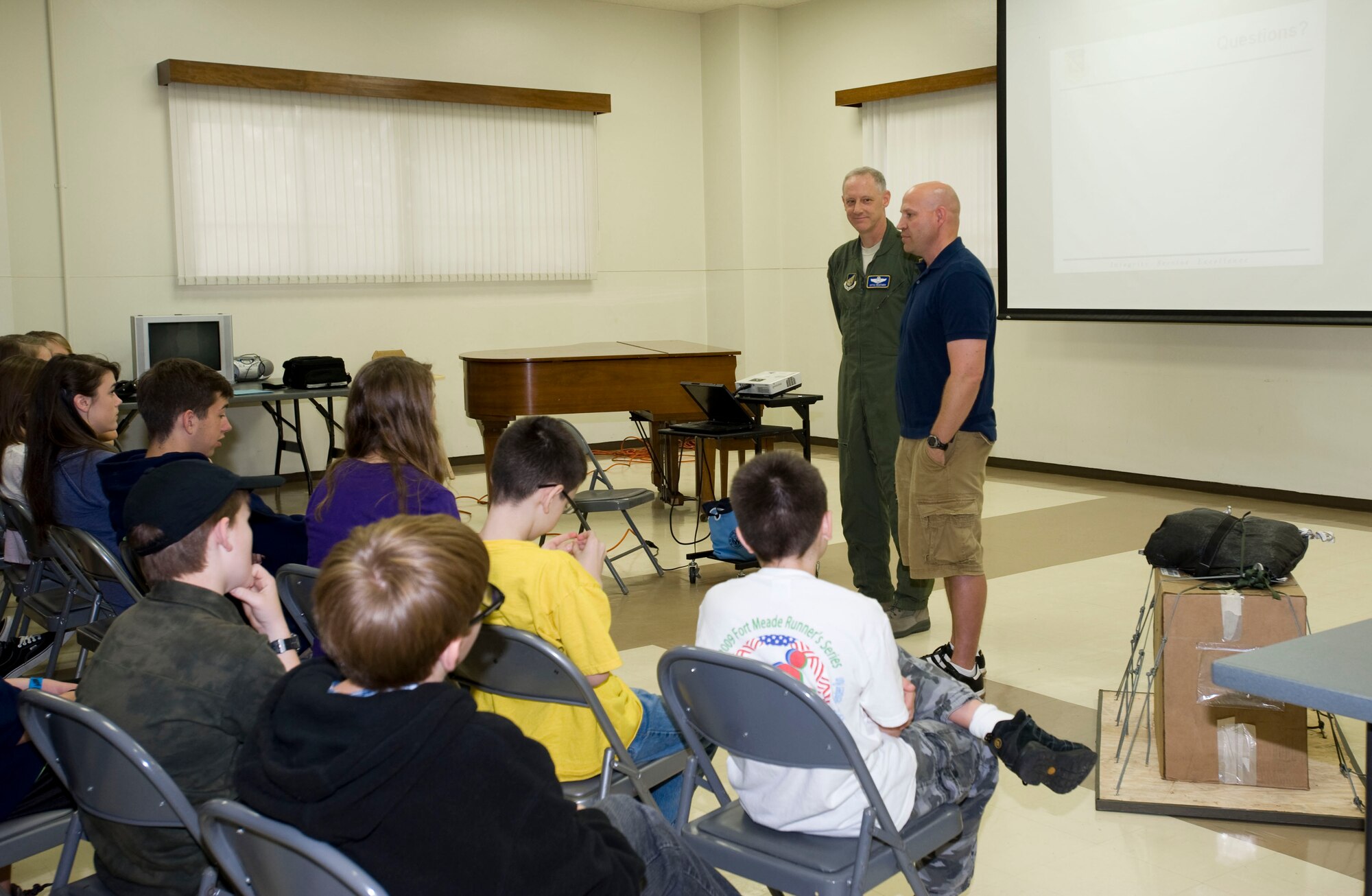 YOKOTA AIR BASE, Japan -- Maj. Jerry Hoopes, 374th Family Advocacy officer, thanks Col. Otto Feather, 374th Airlift Wing commander, after the colonel shared with students from Department of Defense schools throughout the Kanto Plain about his experience in last year's Operation Christmas Drop. This December will mark the 24th year that Yokota's C-130s have participated in the event, which brings boxes of goods to islanders throughout Micronesia in the spirit of good cheer. (U.S. Air Force photo/2nd Lt. Christopher Love)