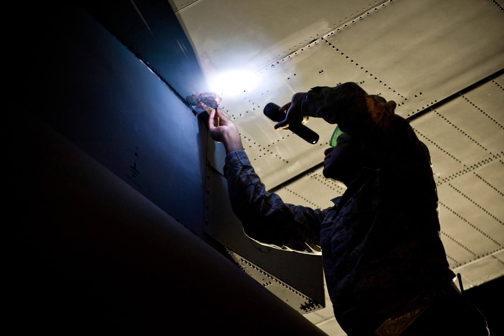 YOKOTA AIR BASE, Japan -- Senior Airman Aaron Porter, 374th Maintenance Squadron fuels systems journeyman, makes a temporary repair on a C-130 Hercules at Yokota Air Base, Japan, Nov. 8, 2011. Airmen from the 374th MXS squadron routinely inspect Yokota?s aircraft to make sure they are running properly. (U.S. Air Force photo/Airman John D. Partlow)
