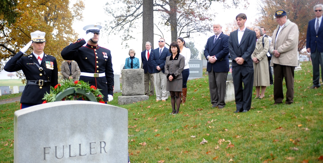 Annapolis, Md. – The family of Maj. Gen. Ben H. Fuller, 15th commandant of the Marine Corps, look on as Maj. Sarah Armstrong, deputy director of Distance Learning Technology Division for the Marine Corps Institute at Marine Barracks Washington, and Lance Cpl. Leo Torres, Marine Corps body bearer, salute while ‘Taps’ is played during a wreath-laying ceremony at Fuller’s gravesite in Annapolis, Md., Nov. 10. (Official Marine Corps Photo by Cpl. Jeremy Ware/Released)