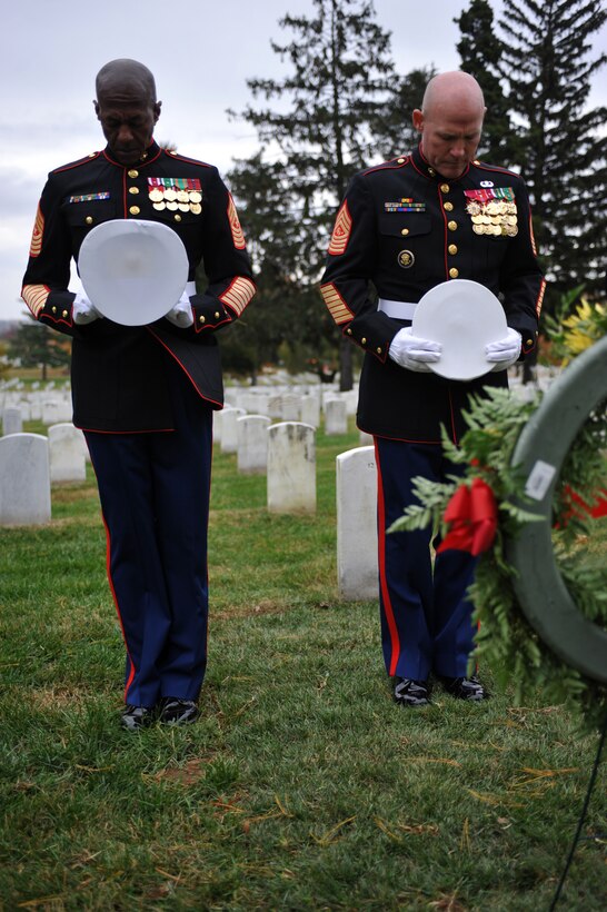 Sgt. Maj. Eric Stockton, Marine Barracks Washington sergeant major, and Sgt. Maj. Micheal P. Barrett, sergeant major of the Marine Corps, pause for a moment of silence after laying a wreath at the grave of Sgt. Maj. Herbert Sweet, fourth sergeant major of the Marine Corps, at Arlington National Cemetery Nov. 10. Six teams from the Barracks, including Barrett and the assistant commandant of the Marine Corps, visited various graves of former commandants and sergeants major of the Marine Corps in the National Capital Region to honor those former leaders of the Corps for the Marine Corps birthday.::r::::n::