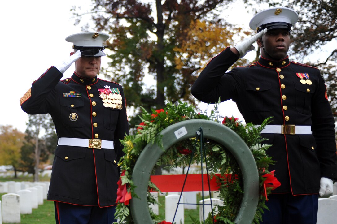 Sgt. Maj. Micheal P. Barret, sergeant major of the Marine Corps, and Lance Cpl. Dusten Reevs, Marine Corps body bearer from Marine Barracks Washington, salute the grave of Sgt. Maj. Herbert Sweet, fourth sergeant major of the Marine Corps, at Arlington National Cemetery Nov. 10. Six teams from the Barracks, including Barrett and the assistant commandant of the Marine Corps, visited various graves of former commandants and sergeants major of the Marine Corps in the National Capital Region to honor those former leaders of the Corps for the Marine Corps birthday.::r::::n::