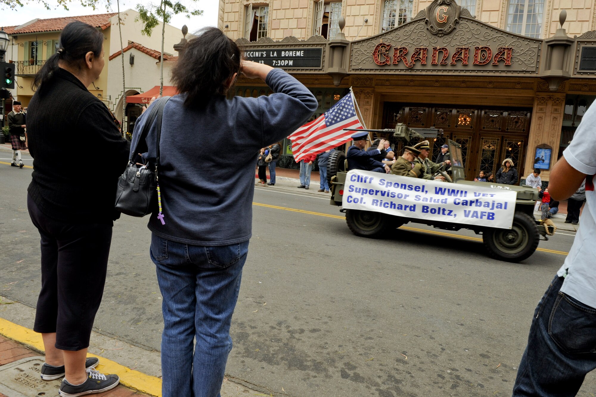VANDENBERG AIR FORCE BASE, Calif. -- A pedestrian salutes the lead car of the Veterans Day Parade on State Street in Santa Barbara Friday, Nov. 11, 2011. First proclaimed on Nov. 11, 1919, as Armistice Day to celebrate the signing of the Armistice that ended World War I, it was expanded in 1954 to include veterans of all wars and has been known as Veterans Day ever since. (U.S. Air Force photo/Staff Sgt. Levi Riendeau)