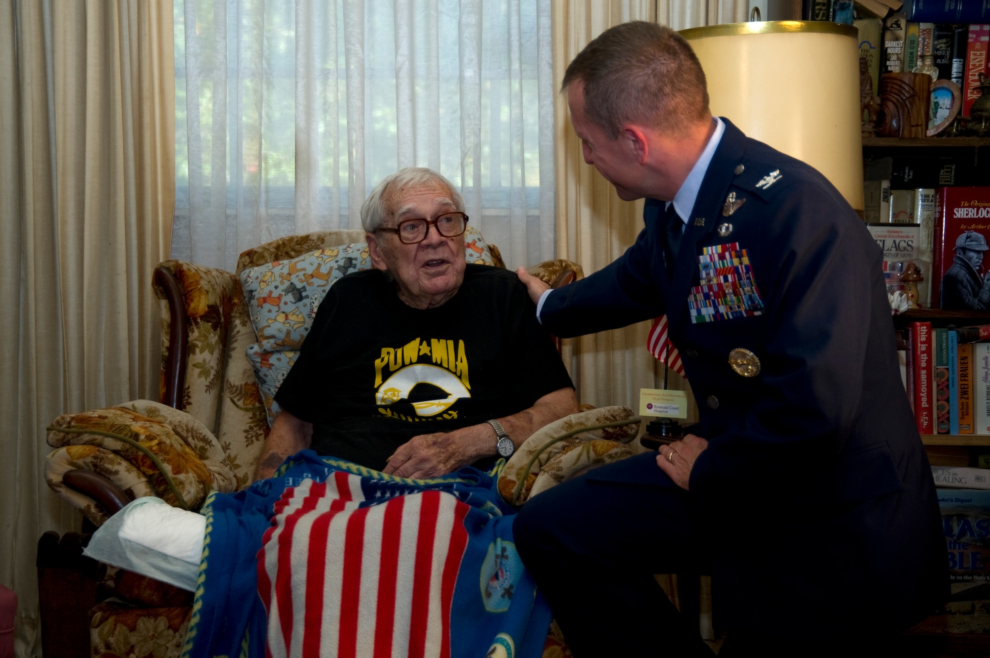 Col. Jim Slife, commander of the 1st Special Operations Wing, offers words of respect and gratitude to retired Tech. Sgt. Pete Loss prior to the Purple Heart ceremony at his private residence in Fort Walton Beach, Nov. 11, 2011. The medal was presented for the sacrifices Loss made during World War II as a prisoner of war and Bataan Death March survivor. (U.S. photo/Airman 1st Class Naomi Griego)(RELEASED)