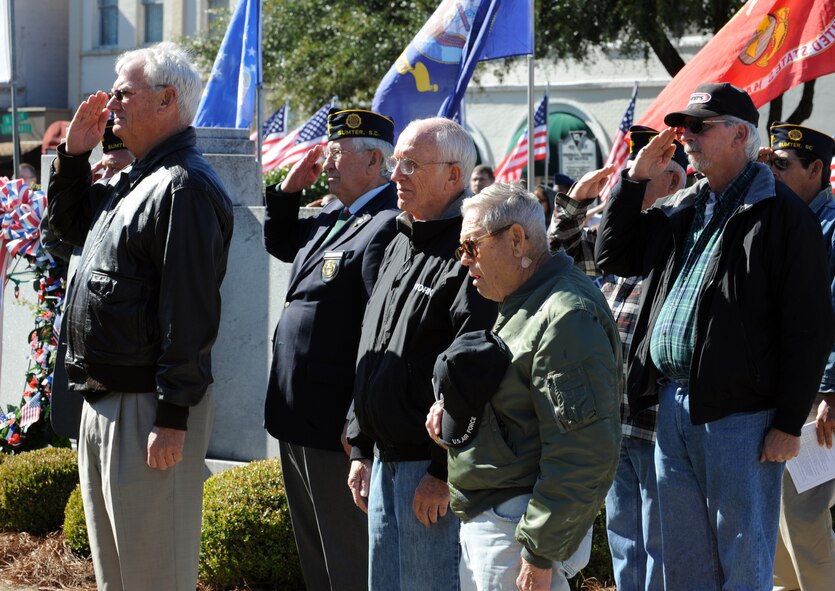 Veterans salute and hold their hands over their hearts during the Prisoners of War/Missing in Action tribute during the Veterans Day Ceremony, Sumter County Courthouse, S.C., Nov. 11, 2011. The Sumter County Veterans Association joined with Team Shaw and the Sumter community to remember those who have given so much in the defense of American freedoms and ideals.(U.S. Air Force photo by Airman 1st Class Tabatha Duarte/Released)
