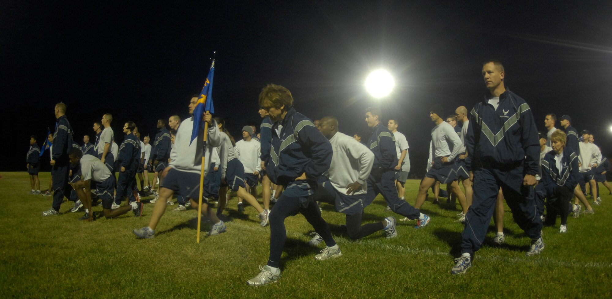 VANDENBERG AIR FORCE BASE, Calif. -- Team V members stretch before a formation run during the Run to Remember closing ceremony at the base track Friday, Nov. 11, 2011. More than 12,000 miles were run by Vandenberg members in honor of the 6,249 military members who lost their lives in support of Operations Iraqi Freedom, Enduring Freedom and New Dawn. (U.S. Air Force photo/Senior Airman Lael Huss)

