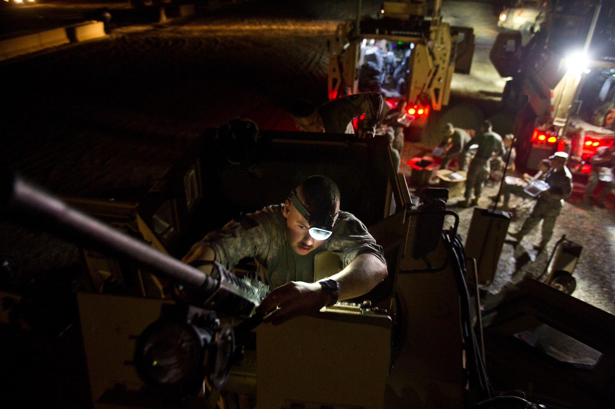 U.S. Army Specialist Nathan Hietala, a gunner assigned to Minnesota Army National Guard's B-Troop, 1-94 Cavalry, Pine City MN, and Esko, MN., native mounts a .50 caliber machine gun on a mine-resistant ambush protected caiman vehicle at Forward Operating Base Warrior, Iraq on Oct. 28, 2011. B-Troop is providing security for a convoy of 43 vehicles tasked with hauling equipment and supplies out of Iraq. (U.S. Air Force Photo/Master Sgt. Jeffrey Allen)
