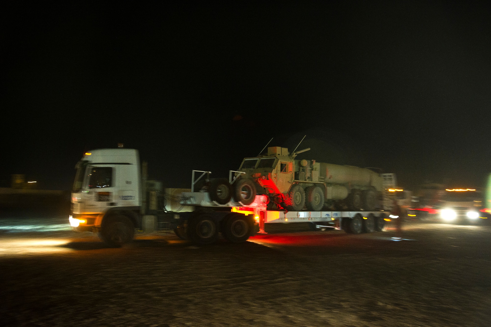 A combination of U.S. Air Force, U.S. Army and Civilian vehicles  depart the staging area at Joint Base Balad, Iraq on Oct. 26, 2011. The staging area is where trucks line up in convoy order before departing on a mission. As the U.S. Military transitions out of Iraq, convoys are used to transport the supplies and equipment out of the country. (U.S. Air Force Photo/Master Sgt. Jeffrey Allen)