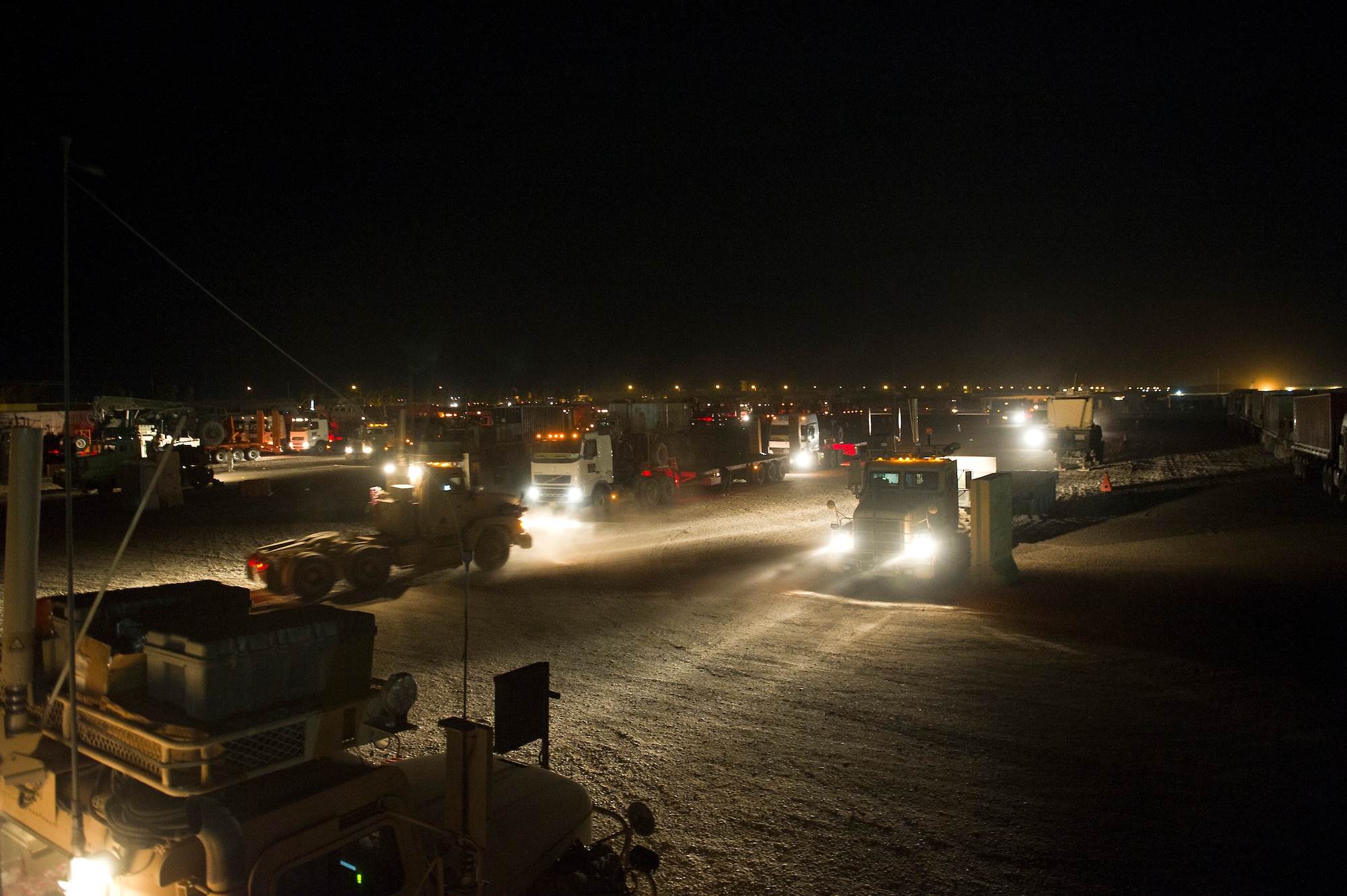 A combination of U.S. Air Force, U.S. Army and Civilian vehicles prepare to depart the staging area at Joint Base Balad, Iraq on Oct. 26, 2011. The staging area is where trucks line up in convoy order before departing on a mission. As the U.S. Military transitions out of Iraq, convoys are used to transport the supplies and equipment out of the country. (U.S. Air Force Photo/Master Sgt. Jeffrey Allen)