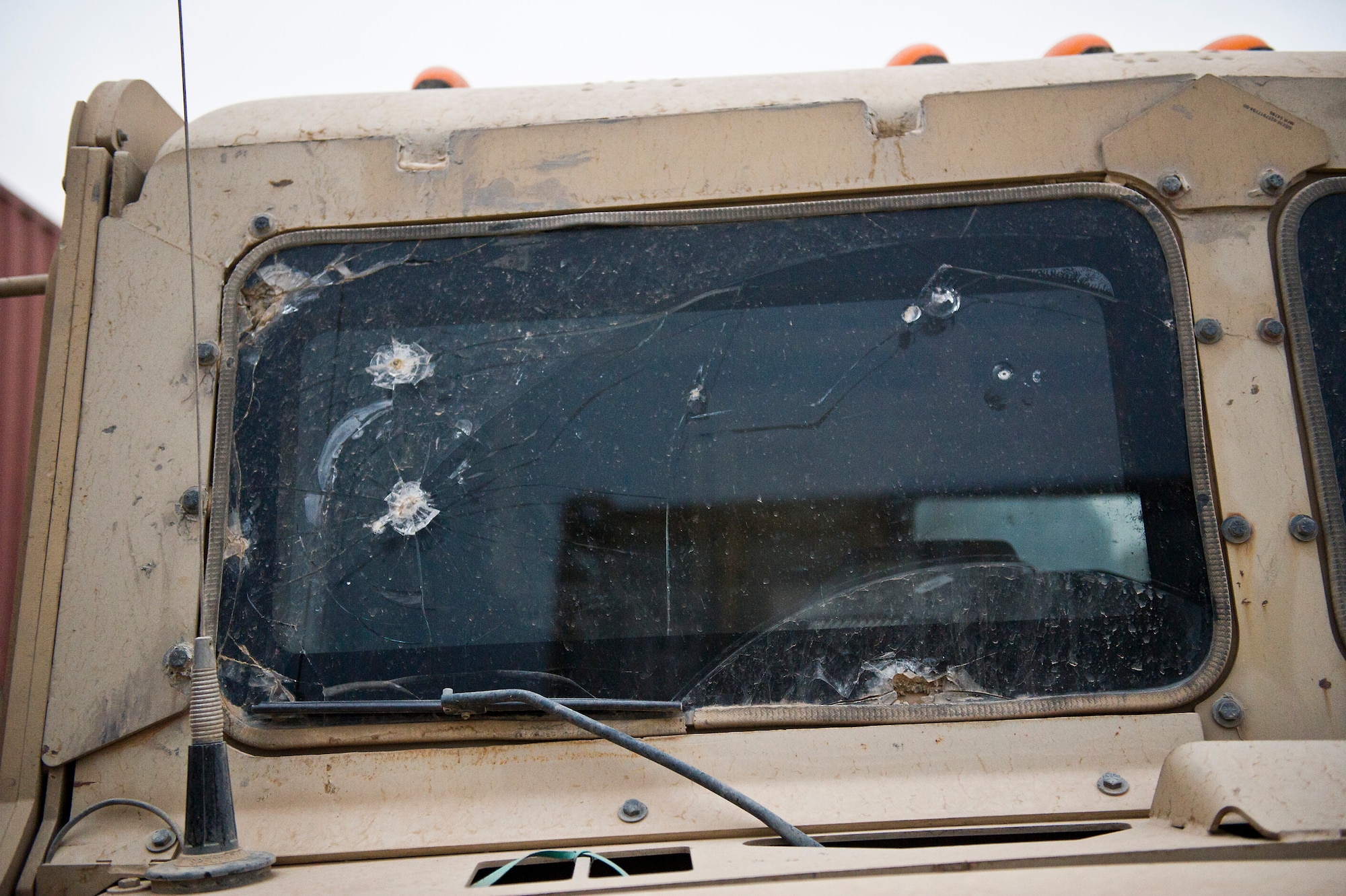 The bullet and rock scarred windshield of an M915 tractor serves as a reminder of just some of the threats facing convoy crews traveling in Iraq. The U.S. Air Force's 70th medium truck detachment uses M915s to provide line-haul support to Joint Logistics Task Force 6 by transporting equipment out of Iraq. (U.S. Air Force Photo/Master Sgt. Jeffrey Allen)