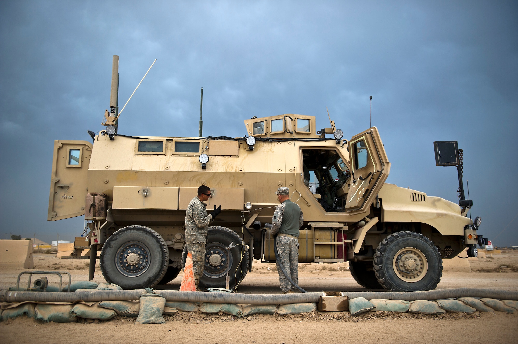 U.S. Army Sgt. Arthur Wemhoff,  Minnesota Army National Guard's B-Troop, 1-94 Cavalry, Pine City MN., refuels his mine-resistant ambush protected caiman vehicle at Joint Base Balad, Iraq on Oct. 26, 2011. B-Troop is providing security for a convoy of 43 vehicles tasked with hauling equipment and supplies out of Iraq. (U.S. Air Force Photo/Master Sgt. Jeffrey Allen)
