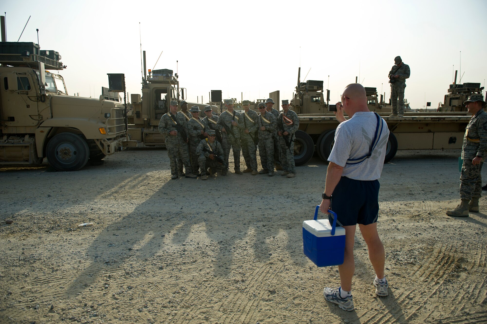 Members or the 70th medium truck detachment pose for a team photo before departing on a mission to transport equipment out of Iraq on Oct. 23, 2011. Members of the 70th MTD are hauling equipment out of Iraq to meet the deadline for the U.S. military transition from Iraq. (U.S. Air Force Photo/Master Sgt. Jeffrey Allen)