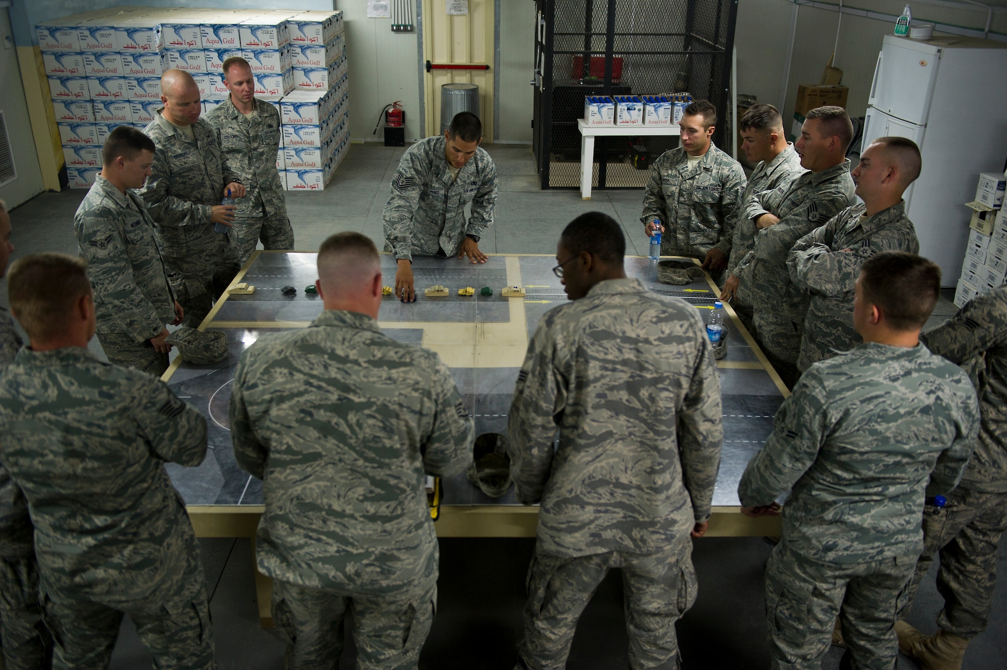 U.S. Air Force Tech. Sgt. David Perez, convoy commander, 70th medium truck detachment and Santa Fe, NM native, briefs his team on convoy tactics during a "rock drill" before departing on a mission to transport equipment out of Iraq on Oct. 22, 2011. Perez is responsible for moving a convoy of 43 vehicles and 60 passengers more than 1,100 miles through Iraq. Members of the 70th MTD are hauling equipment out of Iraq to meet the deadline for the U.S. military transition from Iraq. (U.S. Air Force Photo/Master Sgt. Jeffrey Allen)