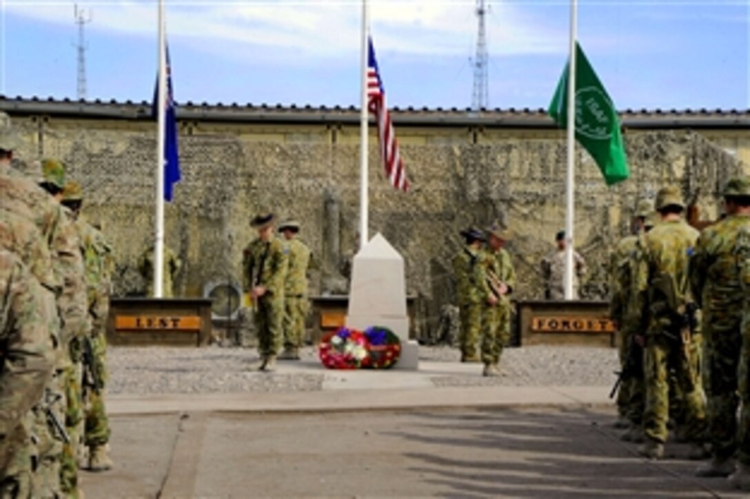 Coalition Forces participate in a Veterans Day remembrance ceremony on Multinational Base Tarin Kowt in Uruzgan, Afghanistan, Nov. 11, 2011.