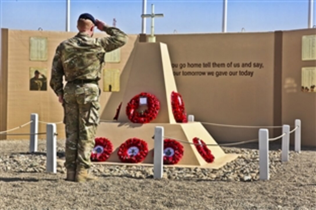 A coalition service member participates in a remembrance ceremony on Camp Bastion in Helmand province, Afghanistan, Nov. 11, 2011.
