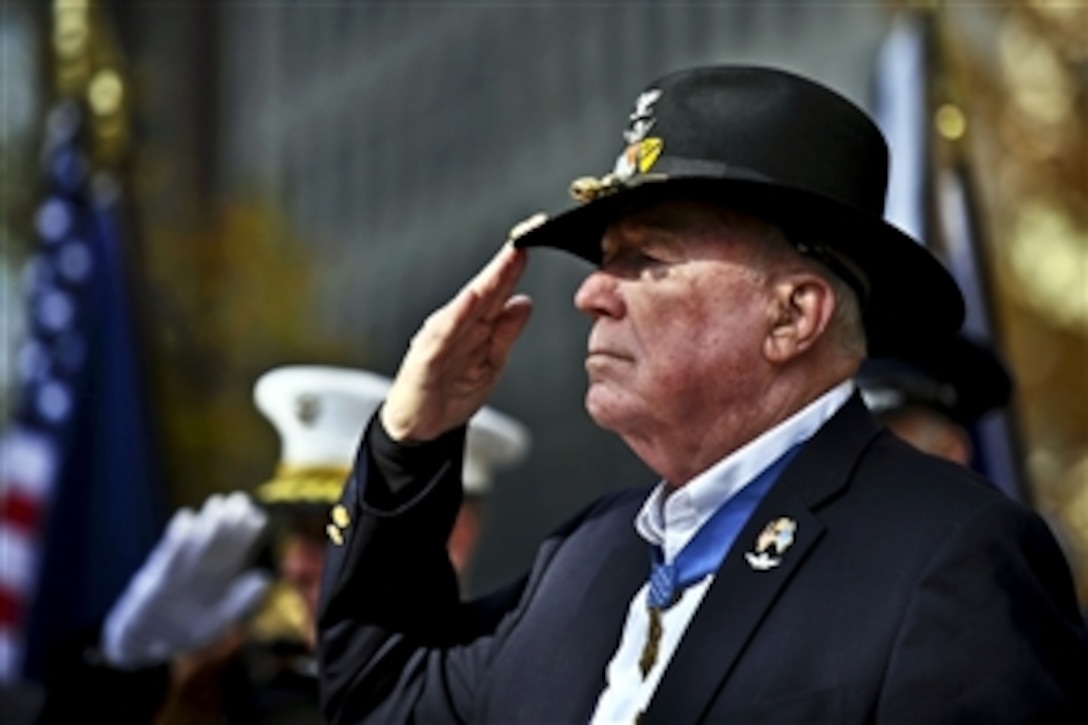 Ret. Army Col. Walter Joseph Marm Jr., recipient of the Medal of Honor, salutes during the playing of the national anthem at Madison Square Park in New York, Nov. 11, 2011.