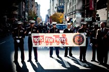 NEW YORK -- Marines from 2nd Battalion, 25 Marine Regiment, Marine Forces Reserve, carried a Toys For Tots banner in the annual New York Veterans Day parade, here, Nov. 11. This year marks the 92st Anniversary of The New York City Veterans Day Parade. The parade is hosted by the United War Veterans Council, Inc. on behalf of the City of New York. It is the oldest and largest of its kind in the nation. Since November 11, 1919, the parade has provided an opportunity for Americans and International visitors to honor those who have served in the nation’s largest city. Sgt. Dakota Meyer, the recently awarded Marine Medal of Honor recipient, rode in the parade. Major Gen. Melvin Spiese, Deputy Commanding General, I Marine Expeditionary Force, represented the Marine Corps as one of the reviewing officials of the parade. The Toys For Tots program collects unopened toys each Christmas season for less fortunate children, see http://www.toysfortots.org/ for more information. (Marine Corps photo by Sgt. Randall A. Clinton / RELEASED)