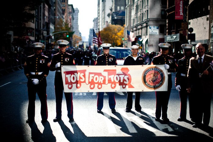 NEW YORK -- Marines from 2nd Battalion, 25 Marine Regiment, Marine Forces Reserve, carried a Toys For Tots banner in the annual New York Veterans Day parade, here, Nov. 11. This year marks the 92st Anniversary of The New York City Veterans Day Parade. The parade is hosted by the United War Veterans Council, Inc. on behalf of the City of New York. It is the oldest and largest of its kind in the nation. Since November 11, 1919, the parade has provided an opportunity for Americans and International visitors to honor those who have served in the nation’s largest city. Sgt. Dakota Meyer, the recently awarded Marine Medal of Honor recipient, rode in the parade. Major Gen. Melvin Spiese, Deputy Commanding General, I Marine Expeditionary Force, represented the Marine Corps as one of the reviewing officials of the parade. The Toys For Tots program collects unopened toys each Christmas season for less fortunate children, see http://www.toysfortots.org/ for more information. (Marine Corps photo by Sgt. Randall A. Clinton / RELEASED)