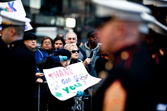 NEW YORK -- Marines from 6th Communications Battalion, Marine Forces Reserve, march past a child saluting them in the annual New York Veterans Day parade, here, Nov. 11. This year marks the 92st Anniversary of The New York City Veterans Day Parade. The parade is hosted by the United War Veterans Council, Inc. on behalf of the City of New York. It is the oldest and largest of its kind in the nation. Since November 11, 1919, the parade has provided an opportunity for Americans and International visitors to honor those who have served in the nation’s largest city. Sgt. Dakota Meyer, the recently awarded Marine Medal of Honor recipient, rode in the parade. Major Gen. Melvin Spiese, Deputy Commanding General, I Marine Expeditionary Force, represented the Marine Corps as one of the reviewing officials of the parade. (Marine Corps photo by Sgt. Randall A. Clinton / RELEASED)