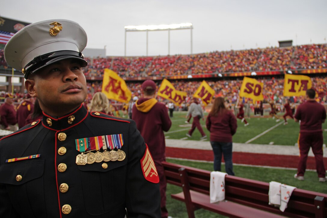 Sgt. Van Tulmau, an infantryman who enlisted in 2002, scans the crowd before the opening kickoff of the Golden Gophers and Wisconsin Badgers matchup Nov. 12. Tulmau served as co-captain for the game with Curran Delaney, a Marine veteran who deployed to Iraq as a sniper. For additional imagery from the event, visit www.facebook.com/rstwincities.