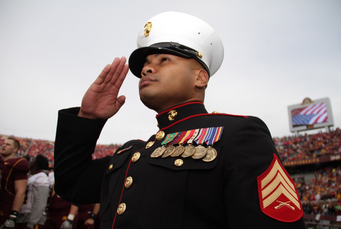 Sgt. Van Tulmau, 30, from Koror, Palau, salutes the American Flag on the Golden Gophers' sideline during the National Anthem Nov. 12. Tulmau was named an honorary co-captain for the game and took part in the coin toss in honor of Veteran’s Day. For additional imagery from the event, visit www.facebook.com/rstwincities.