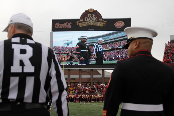 Sgt. Van Tulmau waits for the Golden Gopher and Wisconsin Badger captains to meet midfield for the coin toss Nov. 12. Nearly 50,000 football fans watched Tulmau walk onto the field at TCF Bank Stadium and take part in the opening coin toss in honor of Veteran’s Day. For additional imagery from the event, visit www.facebook.com/rstwincities.