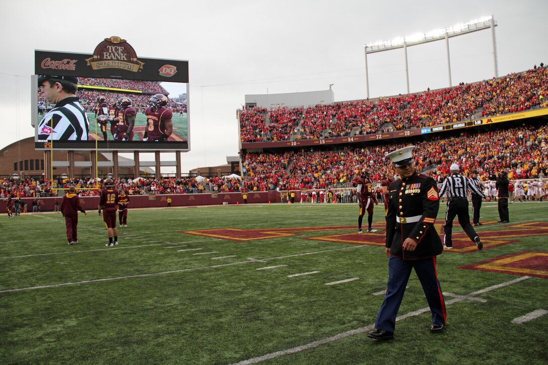 Sgt. Van Tulmau, a 30-year-old Koror, Palau, native, walks off of the field at TCF Bank Stadium after the coin toss for the Golden Gophers and Wisconsin Badgers matchup Nov. 12. Tulmau was named an honorary co-captain for the game in honor of Veteran’s Day. For additional imagery from the event, visit www.facebook.com/rstwincities.