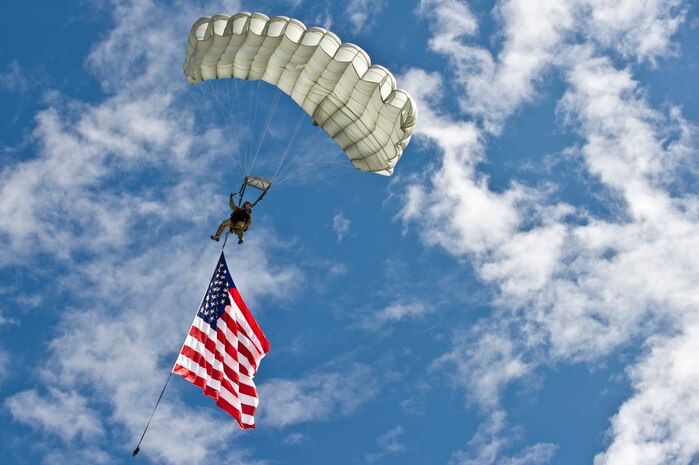 A U.S. Air Force combat controller jumps with the American flag during the 2011 Aviation Nation Open House Nov. 12, at Nellis Air Force Base, Nev. Aviation Nation celebrates 70 years of airpower in Las Vegas and the Air Force's accomplishments in air, space and cyberspace. (U.S. Air Force photo by Senior Airman Brett Clashman/Released)