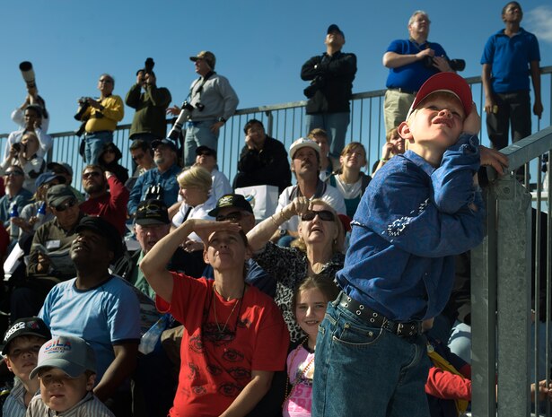 Spectators watch the sky as U.S. Air Force Airmen, 820th RED HORSE airborne flight, jump from a C-130 Hercules during the 2011 Aviation Nation Open House Nov. 12, at Nellis Air Force Base, Nev. Aviation Nation celebrates 70 years of airpower in Las Vegas and the Air Force's accomplishments in air, space and cyberspace. (U.S. Air Force photo by Staff Sgt. Christopher Hubenthal/Released)