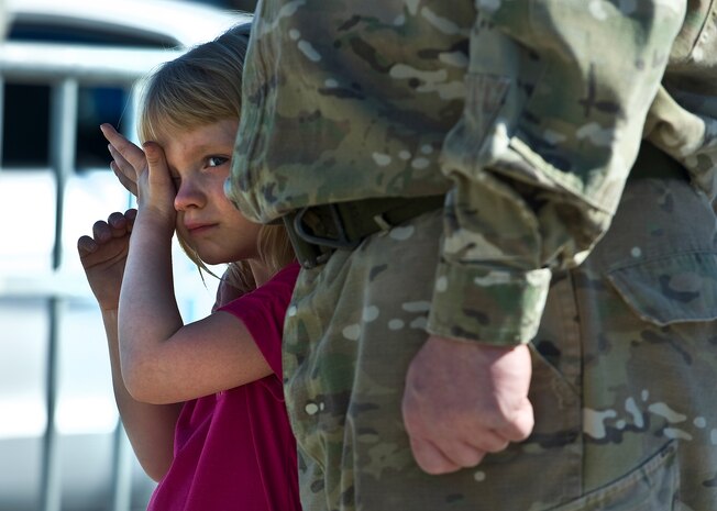 A girl watches a flag folding ceremony during the 2011 Aviation Nation Open House Nov. 12, at Nellis Air Force Base, Nev. Aviation Nation celebrates 70 years of airpower in Las Vegas and the Air Force's accomplishments in air, space and cyberspace. (U.S. Air Force photo by Staff Sgt. Christopher Hubenthal/Released)