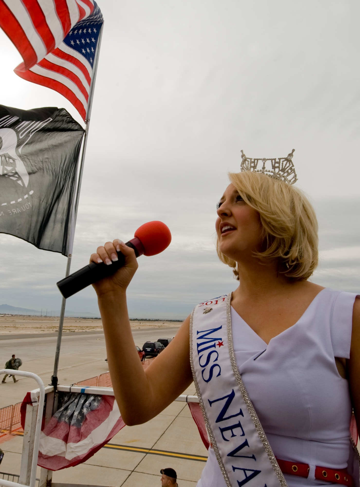 Alana Lee, Miss Nevada 2011, sings the national anthem during the opening ceremony of the 2011 Aviation Nation Open House, Nov. 11, at Nellis Air Force Base, Nev.  Aviation Nation celebrates 70 years of airpower in Las Vegas and the Air Force's accomplishments in air, space and cyberspace.  (U.S. Air Force photo by Senior Airman Stephanie Rubi/Released)