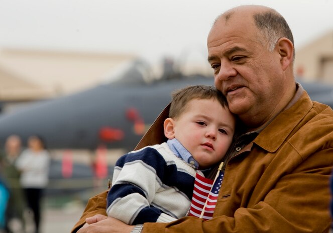 Patircio Zavala holds his grandson Sabastian Zavala during the 2011 Aviation Nation Open House naturalization ceremony  Nov. 11, at Nellis Air Force Base, Nev. Aviation Nation celebrates 70 years of airpower in Las Vegas and the Air Force's accomplishments in air, space and cyberspace.  (U.S. Air Force photo by Senior Airman Stephanie Rubi/Released) 