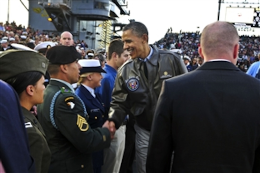 President Barack Obama greets a soldier at the inaugural Quicken Loans Carrier Classic basketball game on the flight deck of the USS Carl Vinson in San Diego, Nov. 11, 2011. 