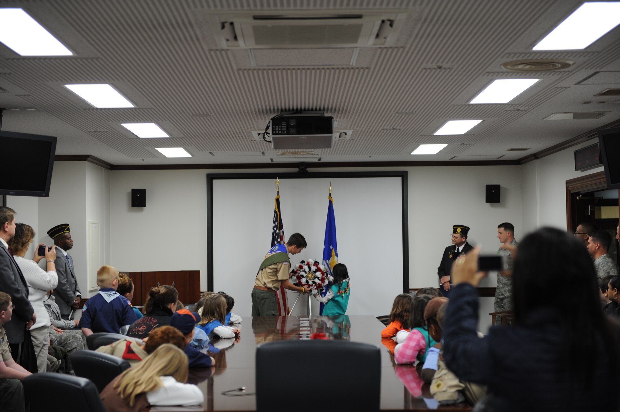 YOKOTA AIR BASE, Japan –- Yokota Scouts place an American Legion wreath to honor Veteran’s Day at a ceremony at the 374th Airlift Wing Headquarters’ conference room here, November 11, 2011. Wing leadership moved the ceremony indoors after the original ceremony was rained out. (U.S. Air Force photo/Capt. Raymond Geoffroy)