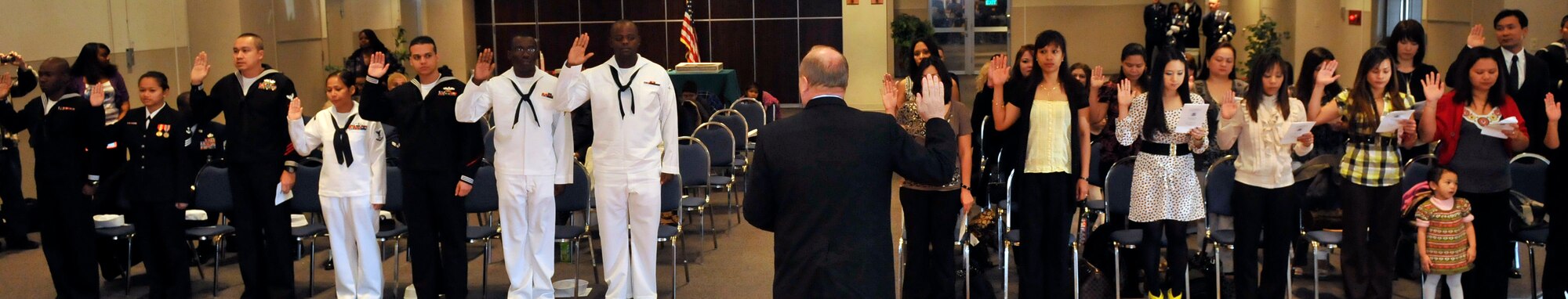 MISAWA AIR BASE, Japan – Walter Haith, U.S. Department of Homeland Security U.S. Citizenship and Immigration Services field office director, leads prospective American citizens in the oath of allegiance here Nov.11. The oath of allegiance is the final step in becoming an American Citizen. For the first time, USCIS agents have come to Misawa to test prospective American citizens and administer the oath of allegiance. (U.S. Air Force photo by Tech. Sgt. Phillip Butterfield)