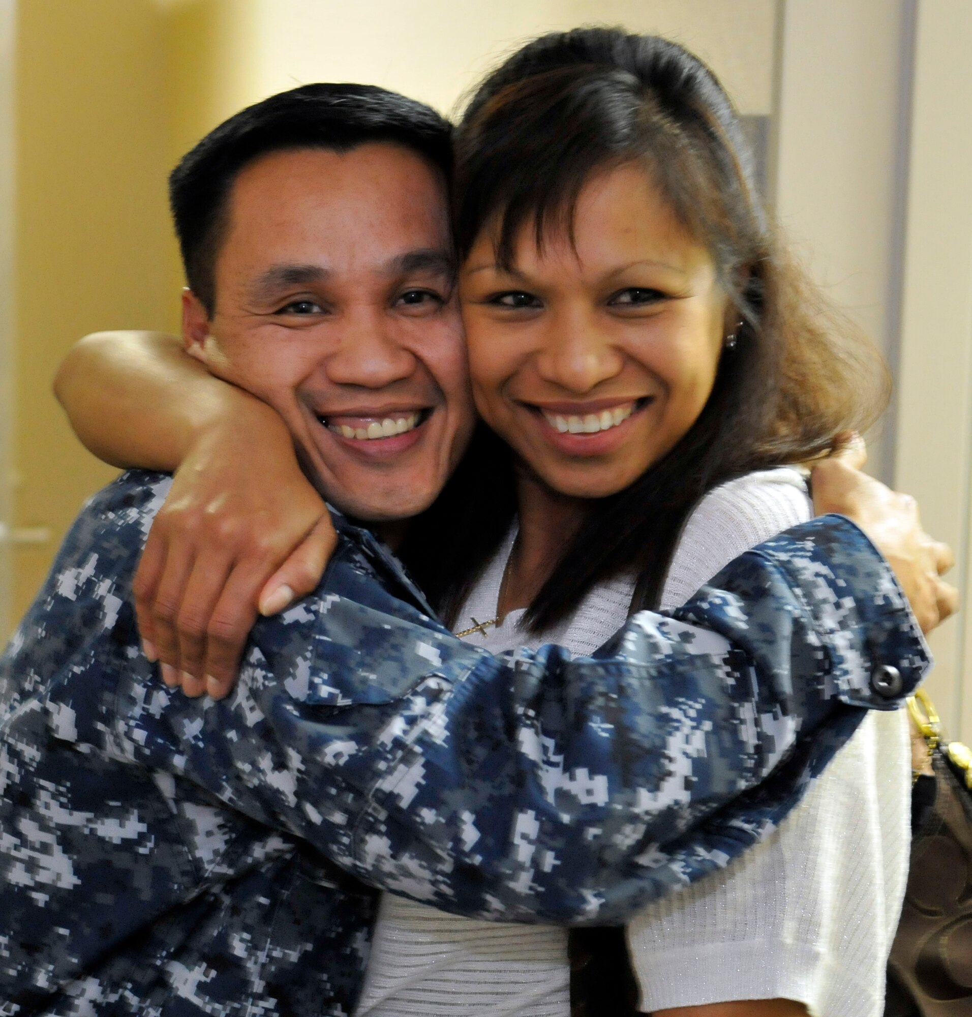 MISAWA AIR BASE, Japan – U.S. Navy Chief Petty Officer Joe Ardon, Navy Air Facility Misawa Navy Supply site director, hugs his wife Jessela Ardon as she comes from the interview room one step closer to her U.S. citizenship here Nov. 10. After passing their interview, prospective U.S. citizens must receive the oath of allegiance during a citizenship ceremony to become full U.S. citizens. For the first time, U.S. Citizenship and Immigration Services agents have come to Misawa to test prospective U.S. citizens and administer the oath of allegiance. (U.S. Air Force photo by Tech. Sgt. Phillip Butterfield)